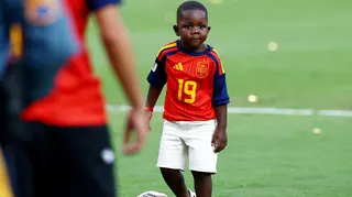 Spain's Lamine Yamal's brother Keyne plays football on the pitch after Spain won the World Cup