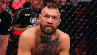 Conor McGregor reacts after an injury stoppage in a UFC welterweight fight.