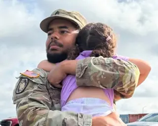 a father hugs his daughter
