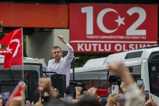 ANKARA, TURKEY - MAY 24: Turkey’s main opposition Republican People's Party's (CHP) Ousted party leader Ozgur Ozel waves to supporters from atop a police water cannon vehicle after being forcibly evicted by police from his party’s headquarters on May 24, 2026 in Ankara, Turkey. Police forcibly took control of the headquarters of Turkey’s main opposition Republican People's Party (CHP) in Ankara, using tear gas and rubber bullets to remove party leader Ozgur Ozel and his supporters after he refus