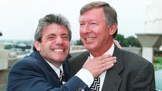 Kevin Keegan jokingly puts his right hand up to a smiling Sir Alex Ferguson's neck
