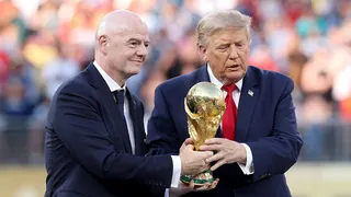 Donald Trump and Gianni Infantino hold the FIFA World Cup trophy at the award ceremony.