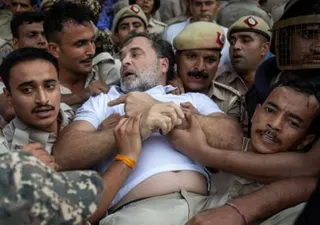 Indian opposition leader Rahul Gandhi is detained by police in  Delhi on Tuesday.