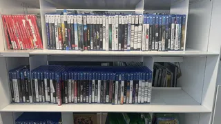 Photo of the Oodi Library in Helsinki showing Switch and PlayStation games on a white library shelf