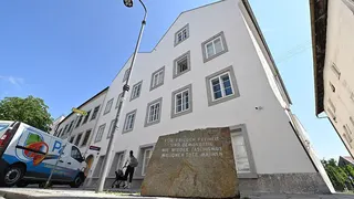 A memorial stone stands in front of the birth house of former German dictator Adolf Hitler that is turned into a police station, in Braunau am Inn