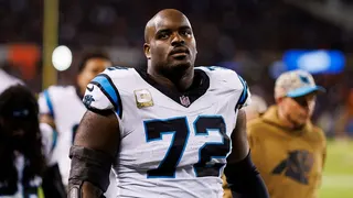 Taylor Moton stands on the sidelines during an NFL game