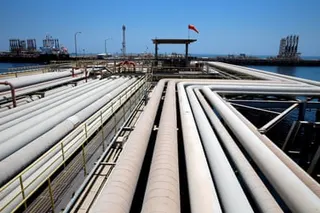 A series of pipes at a refinery and oil terminal in Jeddah, where an oil tanker is being loaded.