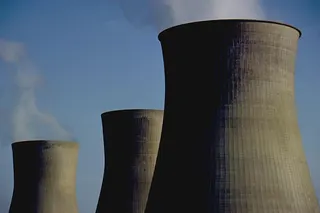The photo shows three huge chimneys of a nuclear power plant, location unspecified.