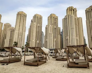 Empty beds are pictured in front of high-rise buildings at Jumeirah beach residence (JBR) in Dubai.