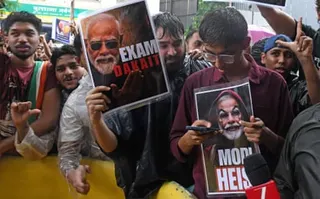 Demonstrators hold anti-Modi placards during a protest