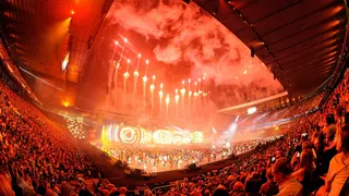 Red fireworks illuminate the night sky over Celtic park during the 2014 Commonwealth Games opening ceremony.