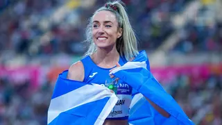 A beaming Eilish McColgan, wrapped in a blue and white saltire, after winning Commonwealth Games gold in 2022
