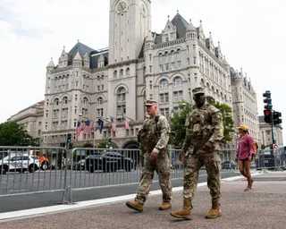 National guard troops walk across the street from the Waldorf Astoria hotel on 24 July 2026.