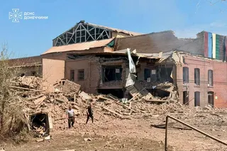 The damage to a building and a pile of rubble at the scene of a Russian missile strike just outside of Kyiv