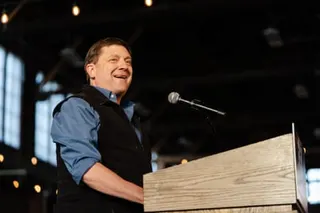 a man in front of a microphone