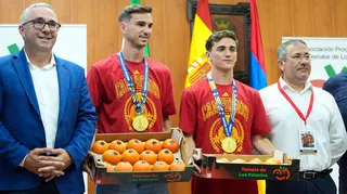 Spain midfielders Fabian Ruiz and Gavi holding a box of tomatoes on a visit back to the hometown of Los Palacios y Villafranca