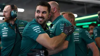 Aston Martin team members celebrate Fernando Alonso's progress into Q2