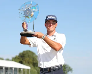 Jackson Koivun holds the trophy after winning the 3M Open golf tournament in Blaine, Minnesota.