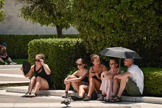 Tourists try to cool off whilst sitting in central Athens July 21, 2026. — AFP pic