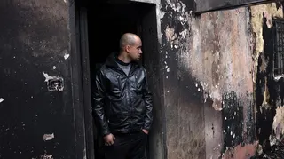 A Palestinian man inspects the remains of his burnt-out family home following a reported attack by Israeli settlers in the village of Fandaqumiya, southwest of Jenin, in the Israeli-occupied West Bank on March 22, 2026.
