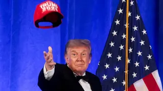 Trump in bow tie, before American flag, tosses red "Trump 2028" cap in air