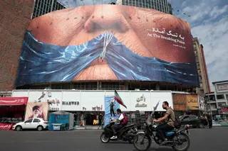 Motorists ride past an anti-US billboard referring to President Donald Trump and the Strait of Hormuz at Valiasr Square in Tehran on May 2, 2026. — AFP pic