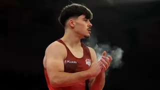 Gabriel Langton of Team England looks on after competing in the floor exercise