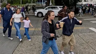 People react as they run away from the scene during an incident