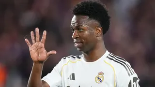 Vinicius Jr holds up his hand during a Champions League match for Real Madrid