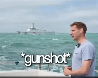 Philp on a boat with another boat visible in the distance