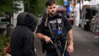 A police officer keeps watch after a mass shooting at the Bite of Seattle food festival