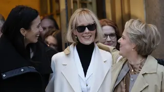E. Jean Carroll, wearing a white coat and sunglasses