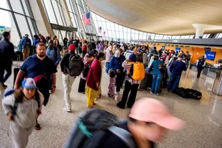 travelers walk in an airport