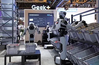 Humanoid robots pick and sort goods at a demonstration warehouse during an expo in Shanghai. Photo: Xinhua