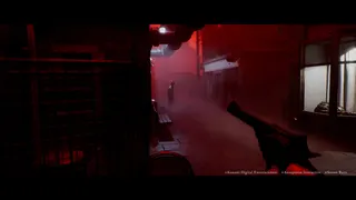 A first-person view down a fog-filled, blood-red alley, with a gun held in frame and a shadowy figure standing in the distance.