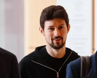 Durov arrives at a Paris courthouse in July 2026. He is 41 with short dark hair and a short dark beard, and wears a black zip-up hoodie.