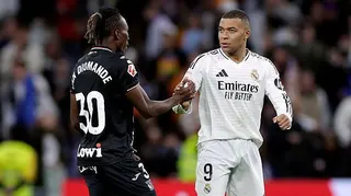 Yan Diomande and Kylian Mbappe shake hands