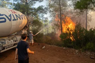A volunteer trying to extinguish a wildfire as it burns in Fethiye, in the southwestern Mugla province of Turkey, on July 30.