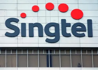 A man looks out of the window of Singtel’s head office in Singapore. Photo: Reuters