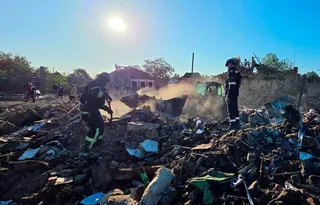 Ukrainian rescuers work in the rubble of a destroyed house following an air attack in Radushne on Thursday. Photo: Dnipropetrovsk Regional Military Administration via AFP