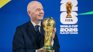 Gianni Infantino holds the World Cup trophy