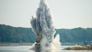 Water and debris fly into the air after the blast