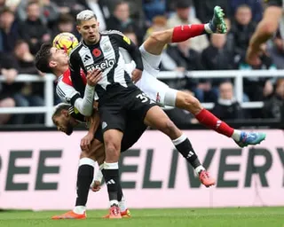 The Newcastle midfielder Bruno Guimarães battles for a loose ball with the Arsenal forward Kai Havertz.