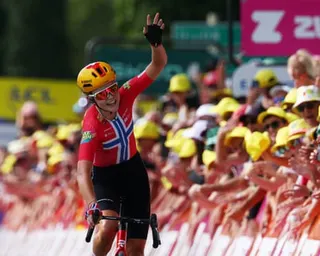 Sigrid Haugset raises her arm in delight after her stage victory