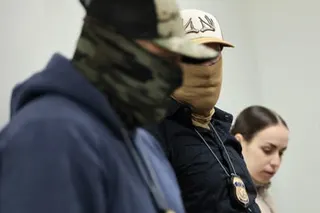 close up of two men wearing masks and a woman without a mask