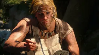 Edward Kenway looking at a piece of paper with a curious expression.