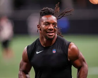 Bijan Robinson smiles during pregame warmups before an NFL game in 2023.
