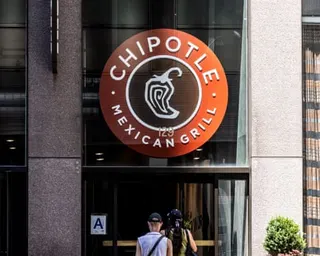 people walk into a Chipotle restaurant
