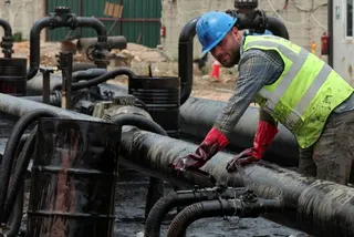 A man works during the unloading of oil from trucks arriving from Iraq at the Baniyas oil terminal, in Baniyas, Syria, May 14, 2026