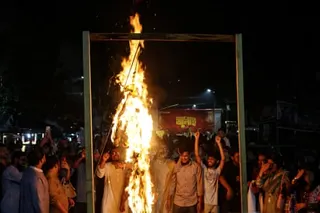 Opponents burn an effigy of Sheikh Hasina